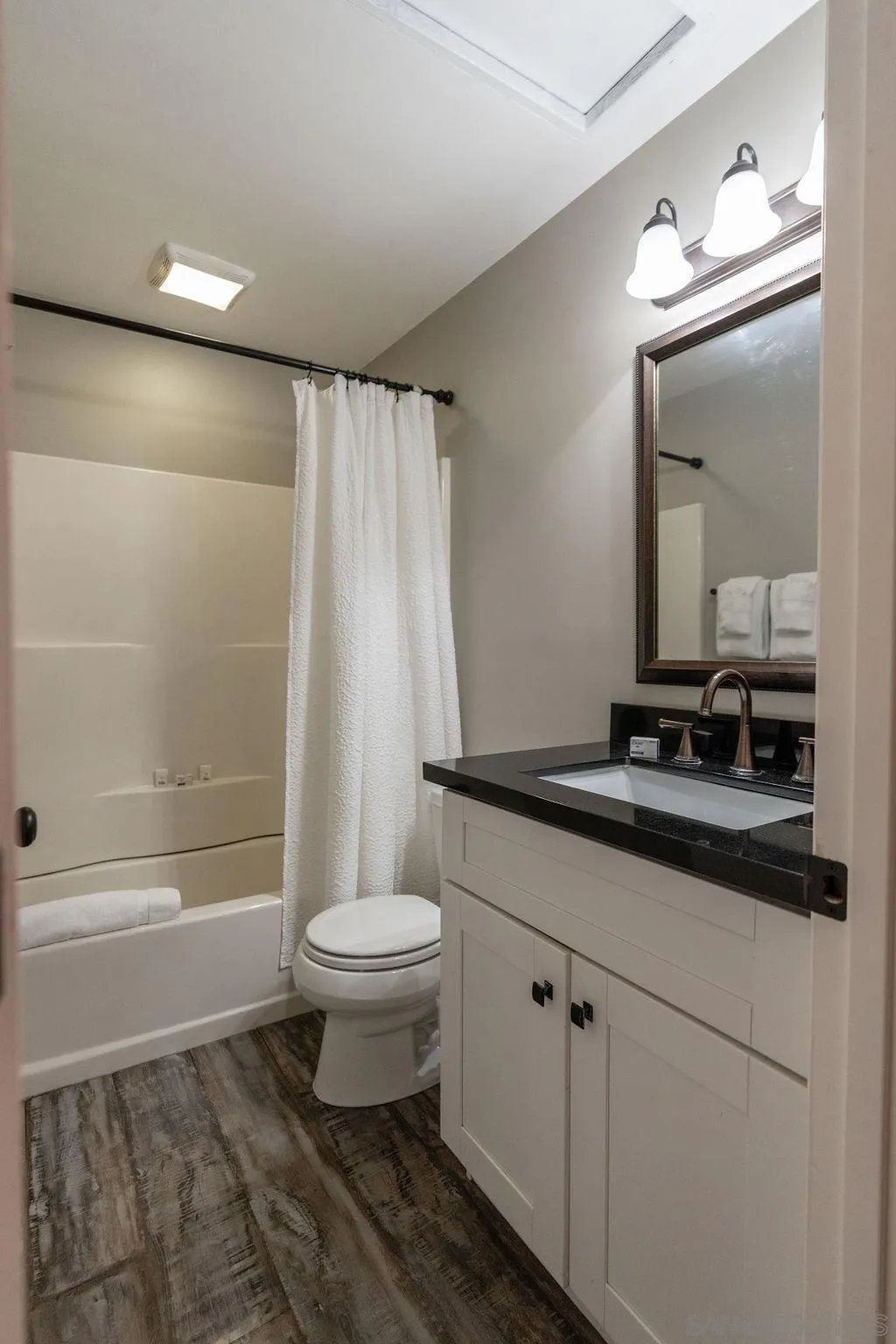 841 Beryl Street, Unit A San Diego, CA 92109 - Photo 13 of 22 a bathroom with a sink a toilet a mirror and shower