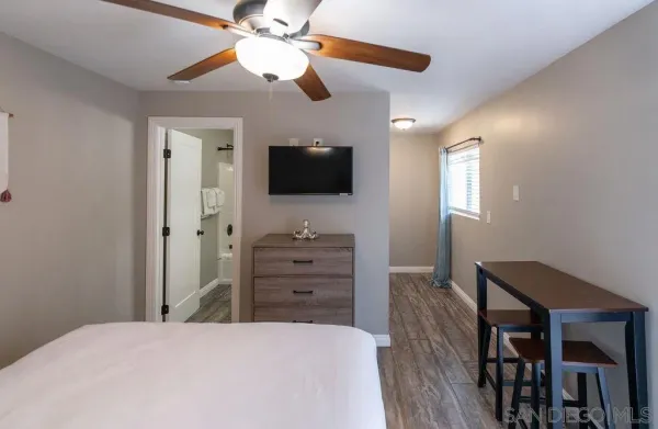 a bedroom with a bed and a flat screen tv