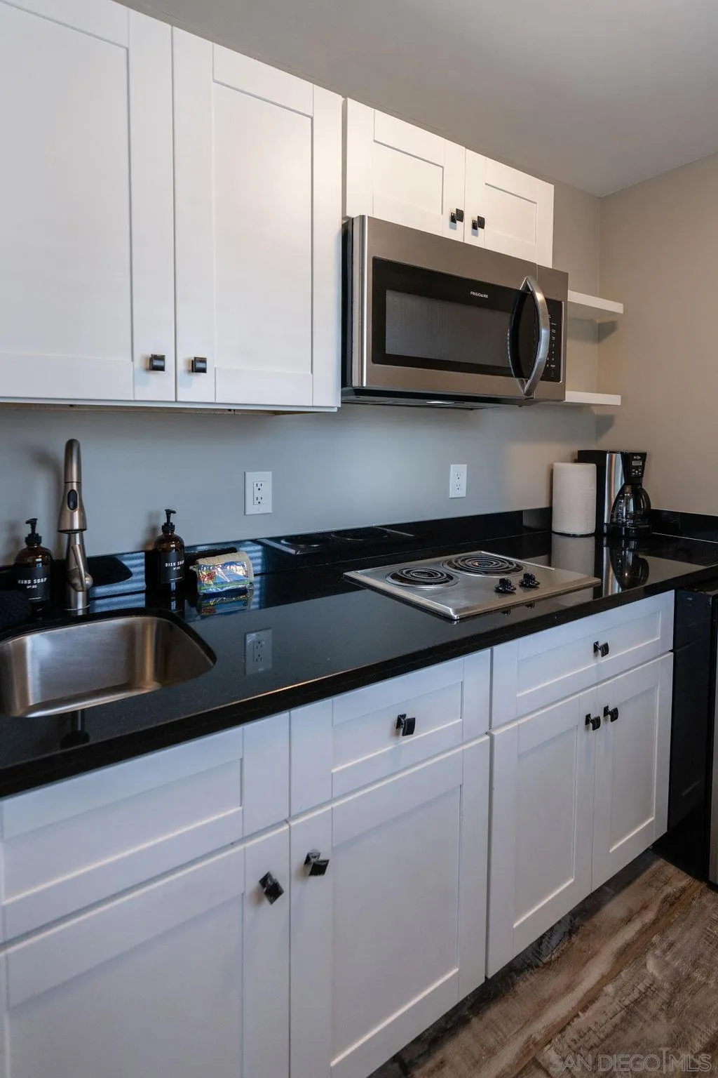 841 Beryl Street, Unit A San Diego, CA 92109 - Photo 9 of 22 a kitchen with stainless steel appliances granite countertop white cabinets sink and dishwasher