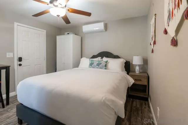 a bedroom with a bed and a chandelier