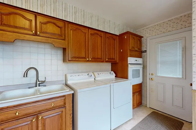a kitchen with a sink cabinets and appliances