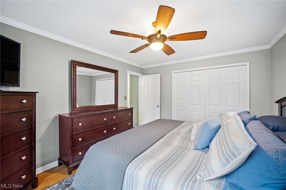 1970 Som Center Road Cleveland, OH 44124 - Photo 20 of 35 Hardwood floored bedroom with ceiling fan, crown molding, and a closet