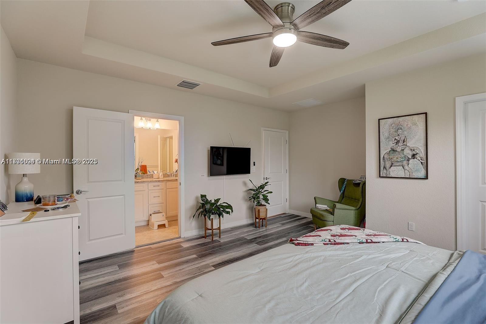 5182 Eucalyptus Drive, Unit 4 Hollywood, FL 33021 - Photo 13 of 22 a bedroom with a bed and a flat screen tv