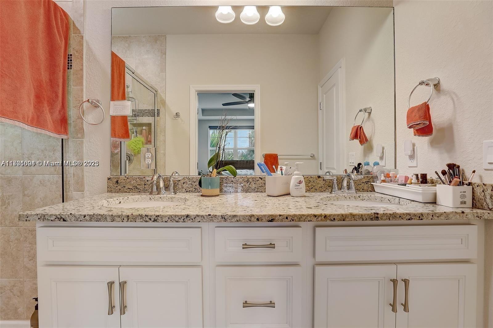 5182 Eucalyptus Drive, Unit 4 Hollywood, FL 33021 - Photo 14 of 22 a bathroom with a granite countertop sink and a mirror