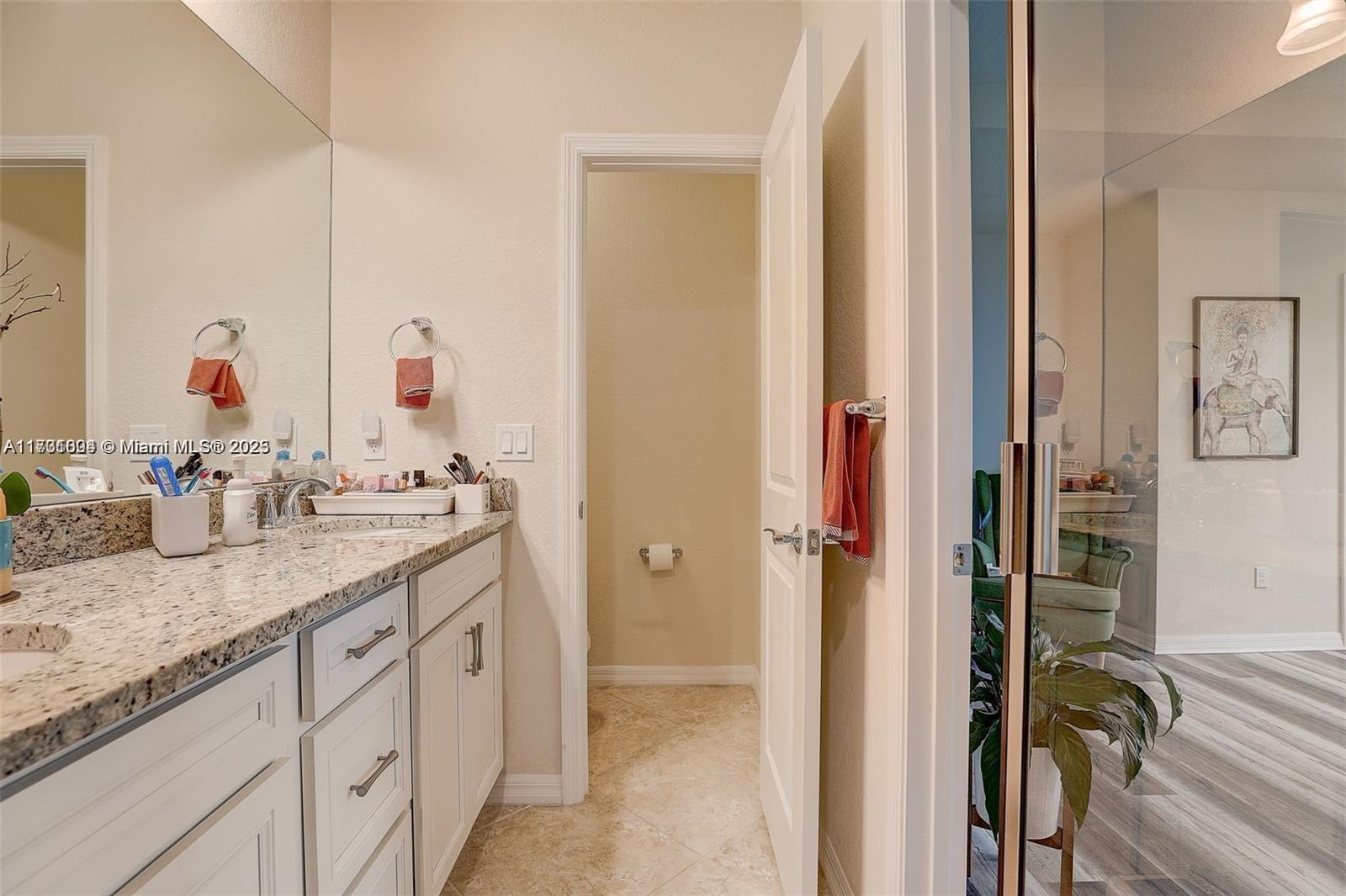 5182 Eucalyptus Drive, Unit 4 Hollywood, FL 33021 - Photo 15 of 22 a bathroom with a granite countertop sink and a mirror