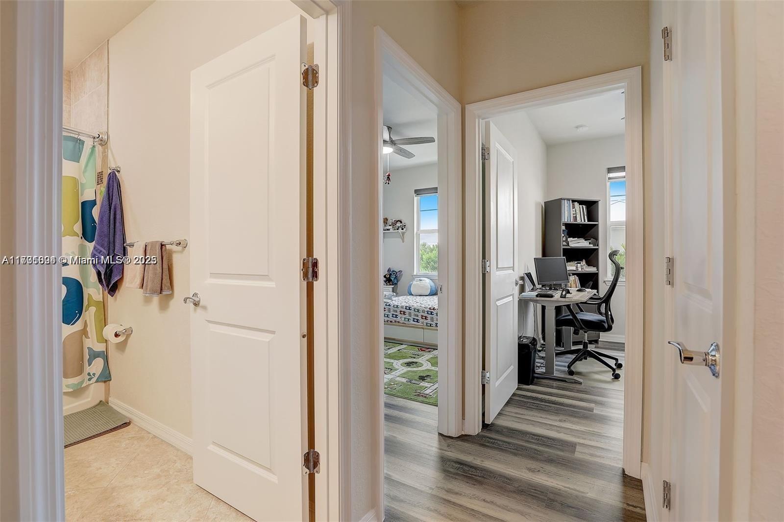 5182 Eucalyptus Drive, Unit 4 Hollywood, FL 33021 - Photo 16 of 22 a view of a hallway with paintings on the wall
