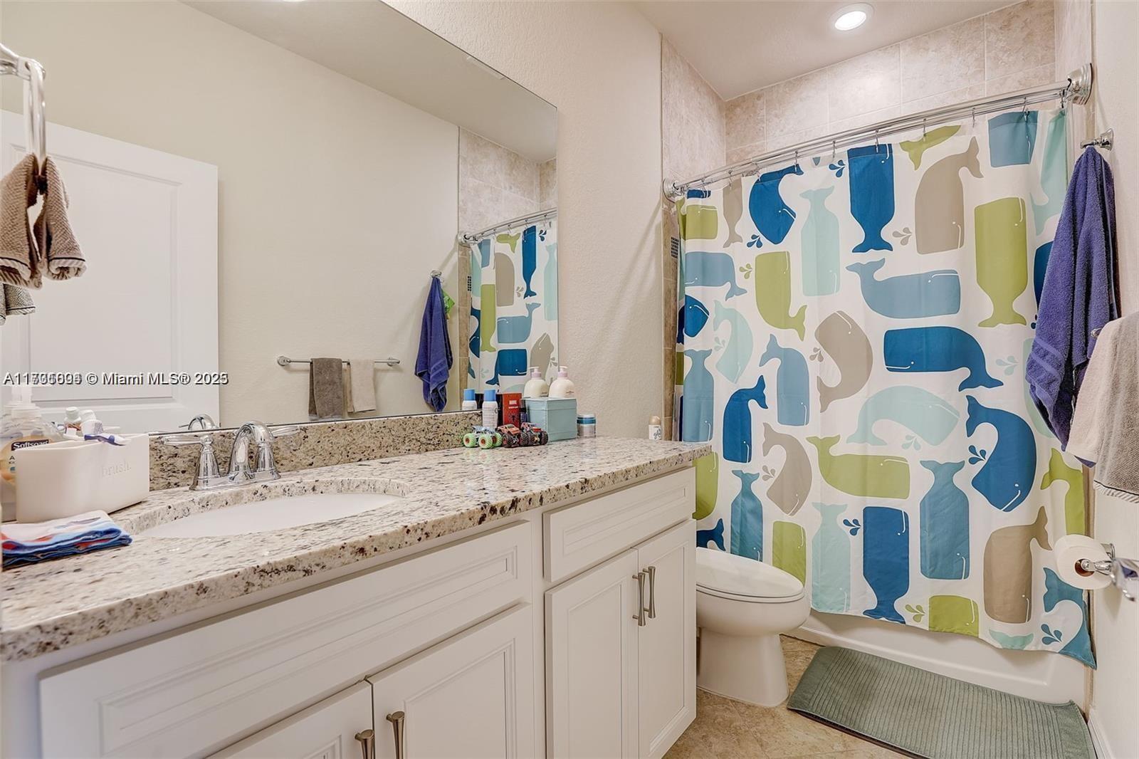 5182 Eucalyptus Drive, Unit 4 Hollywood, FL 33021 - Photo 17 of 22 a bathroom with a granite countertop sink and a mirror