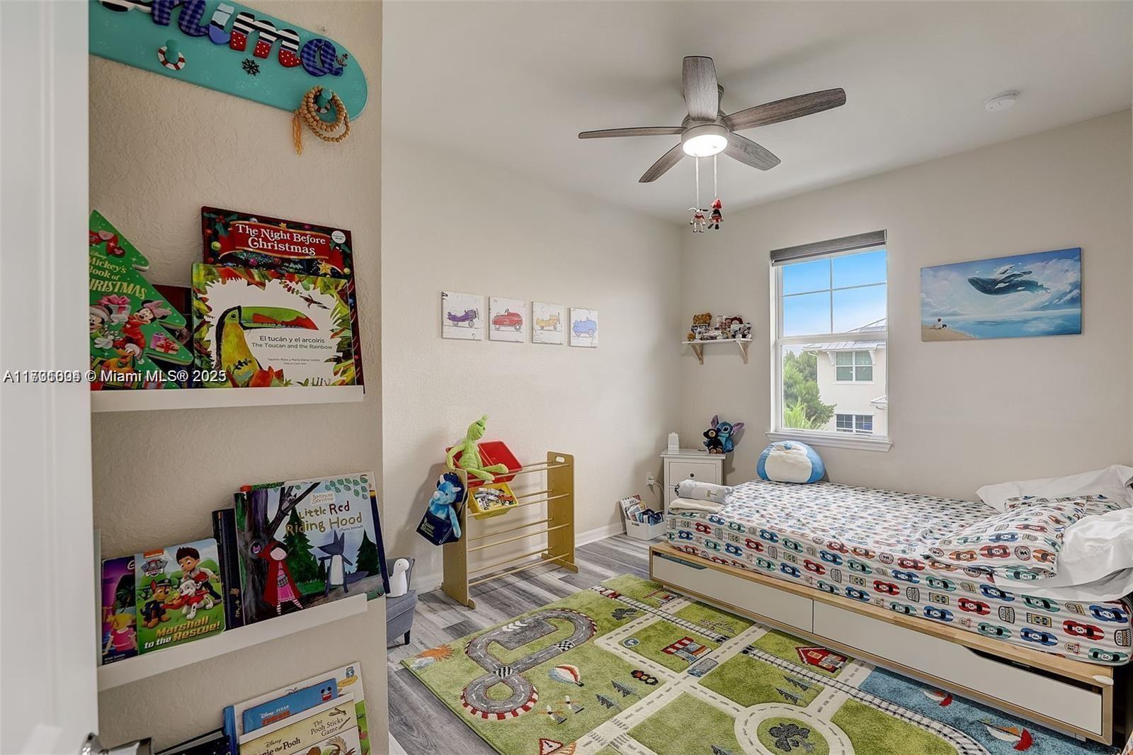 5182 Eucalyptus Drive, Unit 4 Hollywood, FL 33021 - Photo 18 of 22 a bedroom with bed and ceiling fan