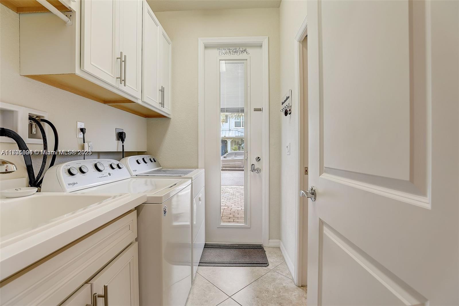 5182 Eucalyptus Drive, Unit 4 Hollywood, FL 33021 - Photo 19 of 22 a utility room with cabinets washer and dryer