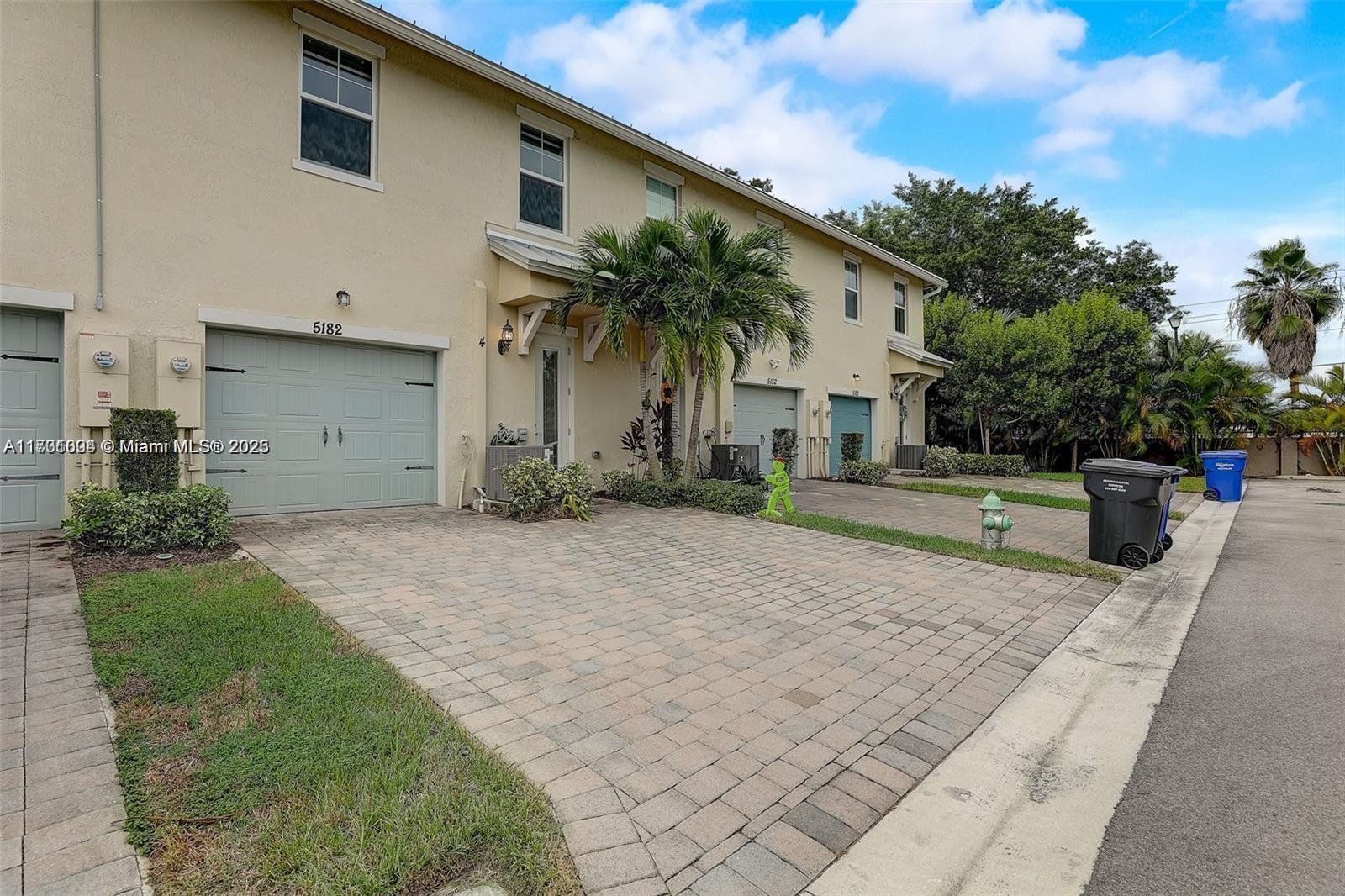 5182 Eucalyptus Drive, Unit 4 Hollywood, FL 33021 - Photo 22 of 22 a front view of a house with a yard and garage