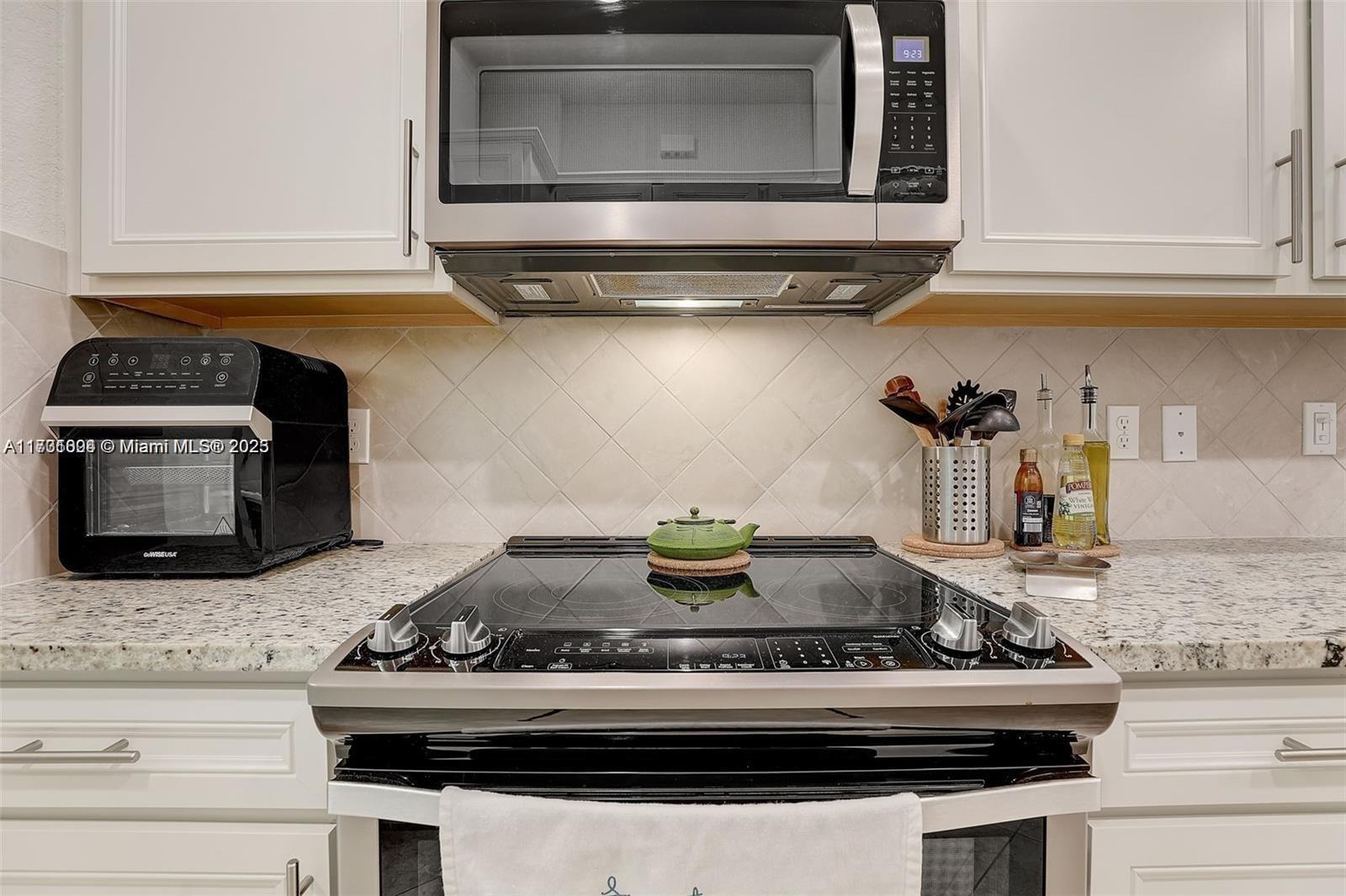 5182 Eucalyptus Drive, Unit 4 Hollywood, FL 33021 - Photo 8 of 22 a stove top oven sitting inside of a kitchen