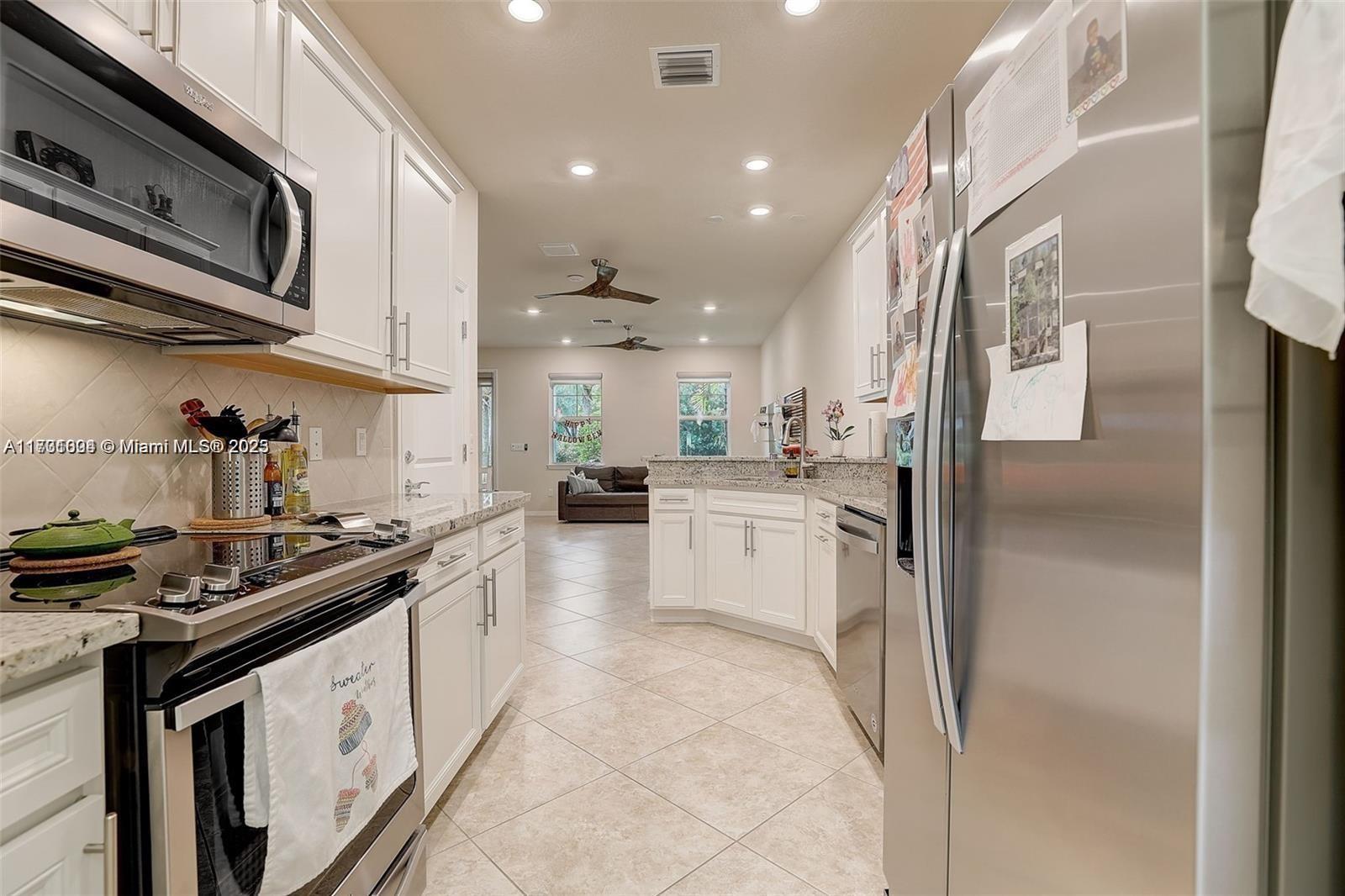 5182 Eucalyptus Drive, Unit 4 Hollywood, FL 33021 - Photo 10 of 22 a kitchen with stainless steel appliances granite countertop a sink and cabinets