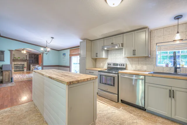 a kitchen with granite countertop cabinets stainless steel appliances and a counter space