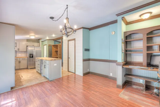 a view of a kitchen and a refrigerator