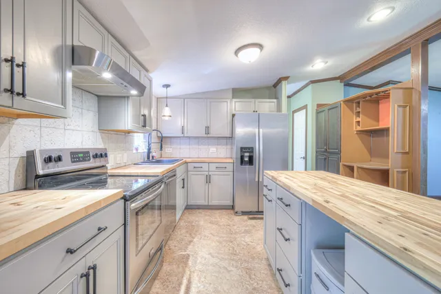 a kitchen with a sink stove and refrigerator
