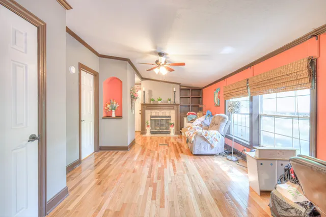 a very nice looking room with wooden floor and windows