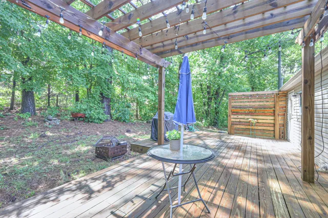 a view of a patio with a table chairs and a backyard