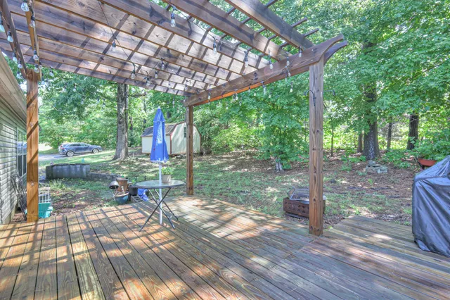 a view of a patio with a table chairs and a backyard