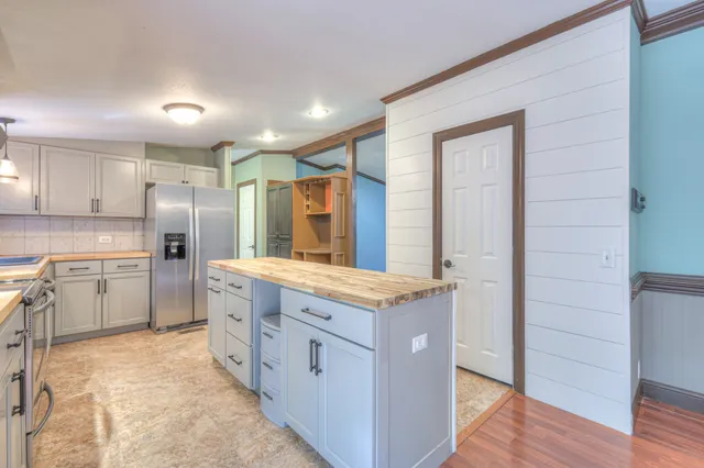 a kitchen with granite countertop cabinets stainless steel appliances and a island