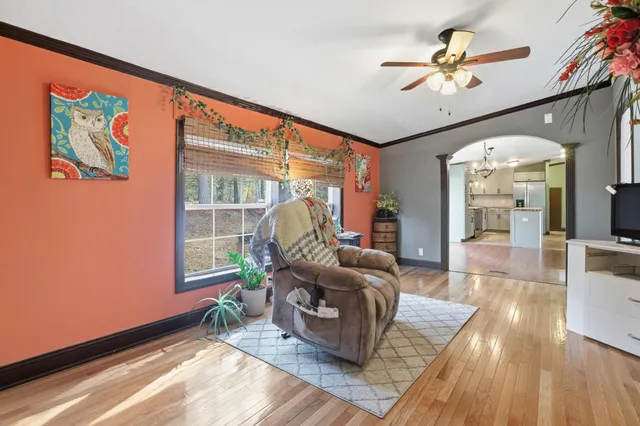 a view of a kitchen with a sink and wooden floor