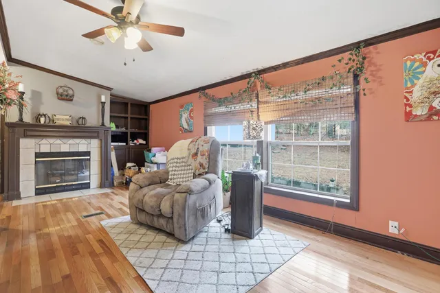 a kitchen with stainless steel appliances granite countertop a stove top oven a sink a refrigerator and white cabinets