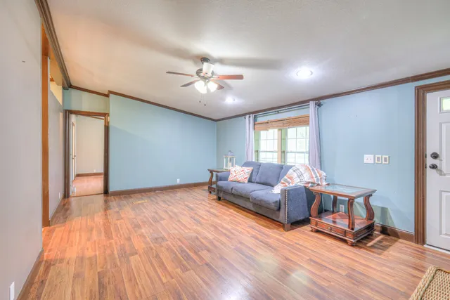 a living room with furniture and wooden floor