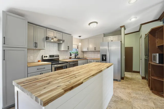 a view of a room with wooden floor and window