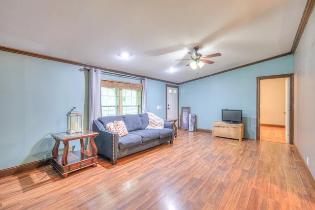 a living room with furniture and a wooden floor