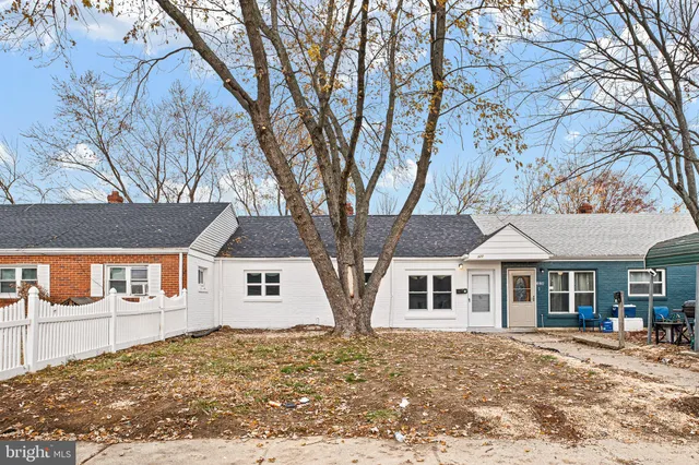 a view of a large trees in front of a house