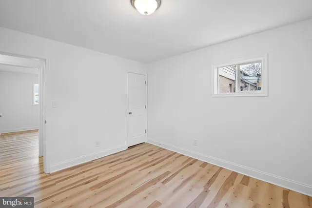 a view of a room with wooden floor