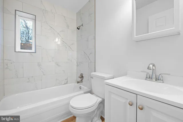 a bathroom with a sink toilet and bathtub