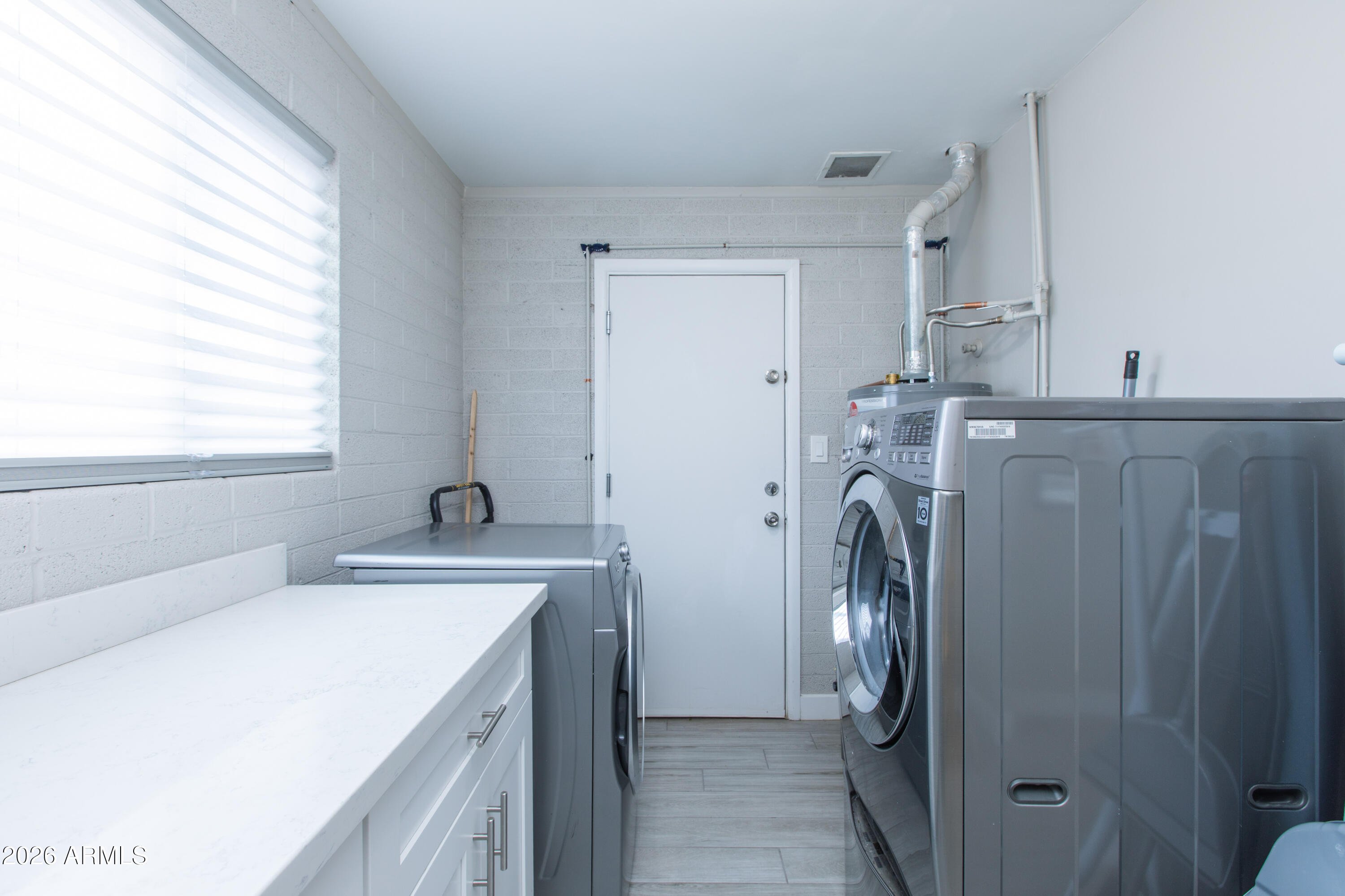 5541 East Cheery Lynn Road Phoenix, AZ 85018 - Photo 28 of 69 a utility room with a sink a washer and dryer