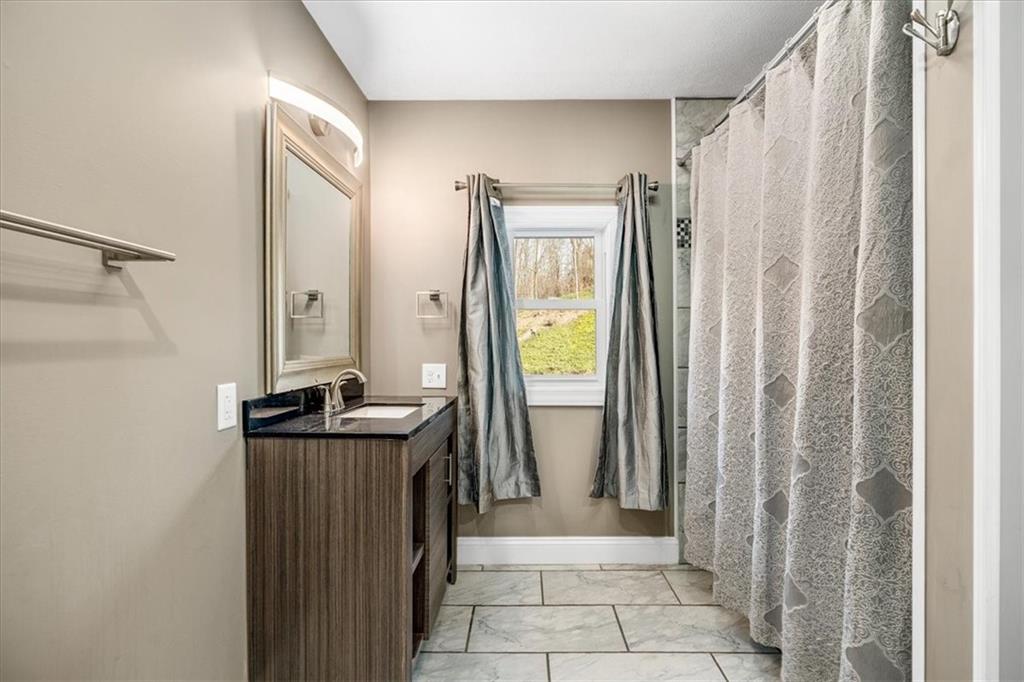 720 Conway Wallrose Road Freedom, PA 15042 - Photo 12 of 25 a view of a bathroom with a tub and shower