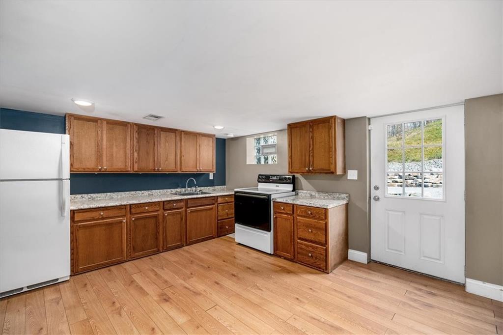 720 Conway Wallrose Road Freedom, PA 15042 - Photo 22 of 25 a kitchen with stainless steel appliances granite countertop a stove a sink dishwasher and a refrigerator