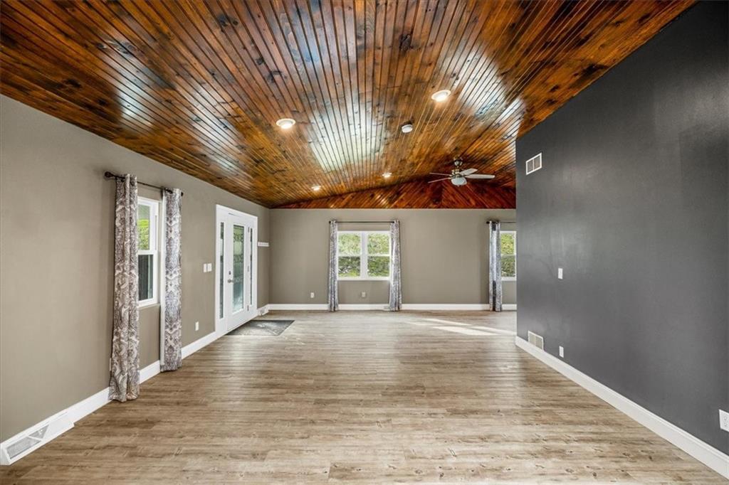 720 Conway Wallrose Road Freedom, PA 15042 - Photo 5 of 25 a view of an empty room with window and chandelier fan