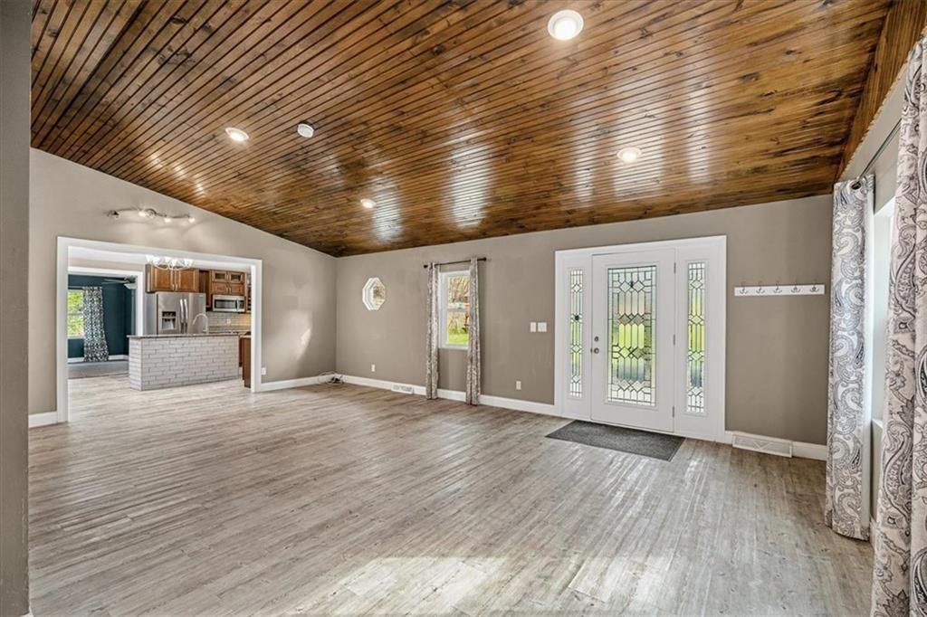 720 Conway Wallrose Road Freedom, PA 15042 - Photo 6 of 25 an empty room with wooden floor and windows