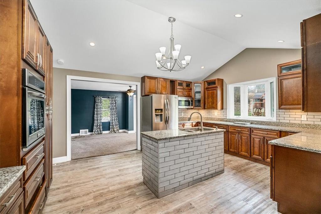 720 Conway Wallrose Road Freedom, PA 15042 - Photo 7 of 25 a large kitchen with kitchen island a large island in the center and stainless steel appliances