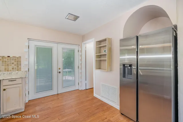 a view of a refrigerator in kitchen and a glass door