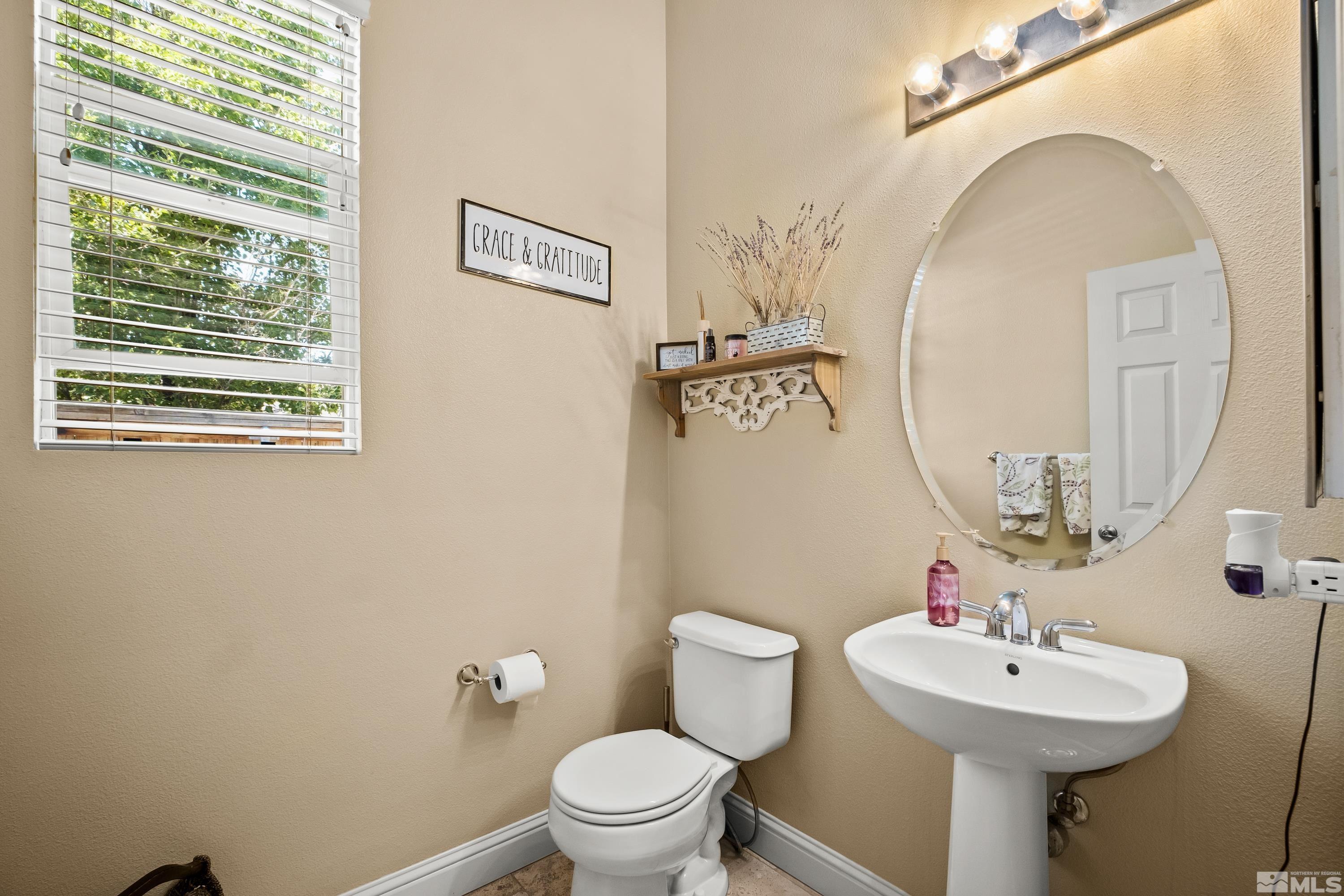 1600 Red Gulch Court Reno, NV 89521 - Photo 12 of 39 a bathroom with a toilet sink and mirror