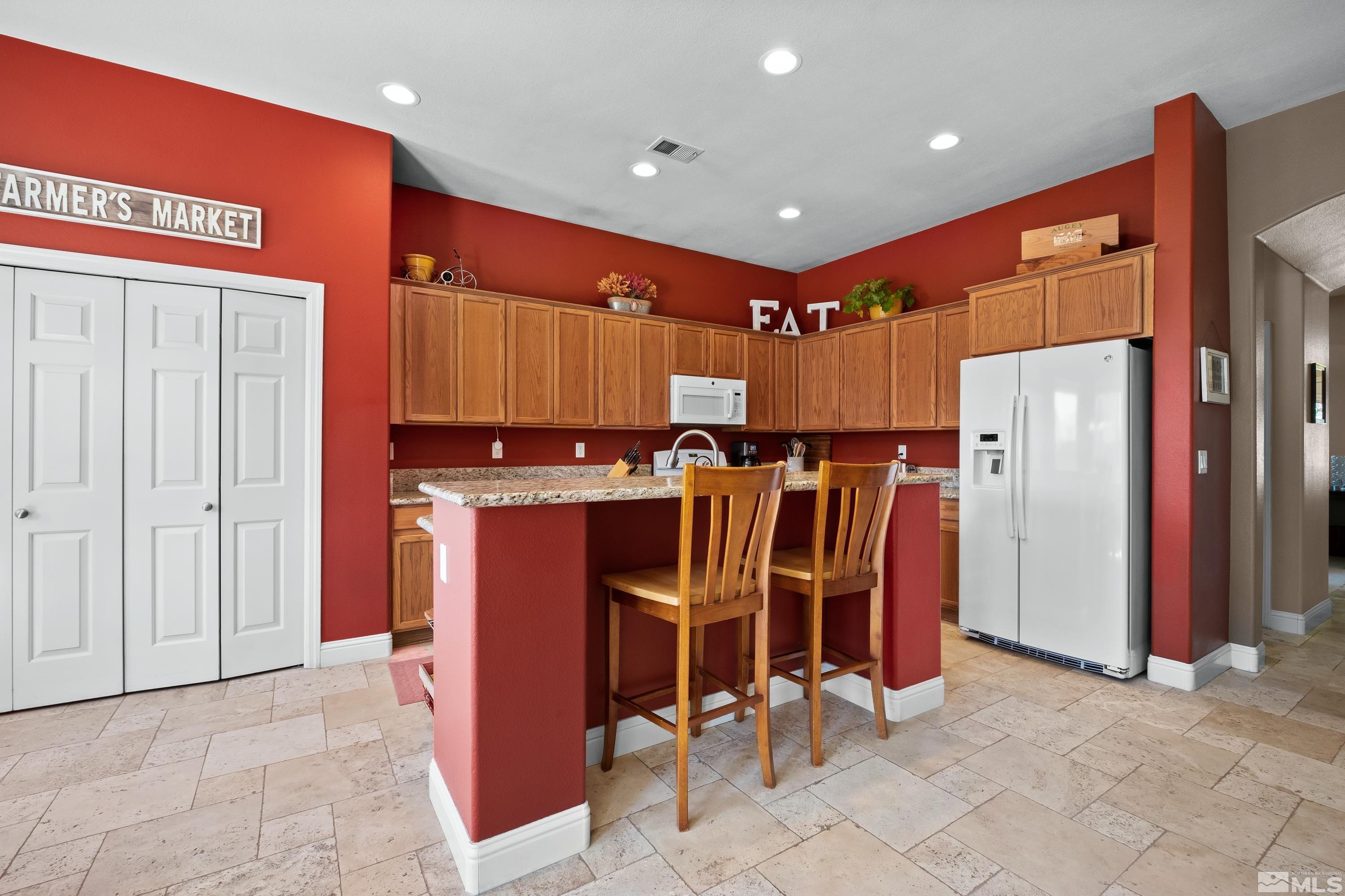 1600 Red Gulch Court Reno, NV 89521 - Photo 15 of 39 a view of a kitchen with refrigerator and chairs