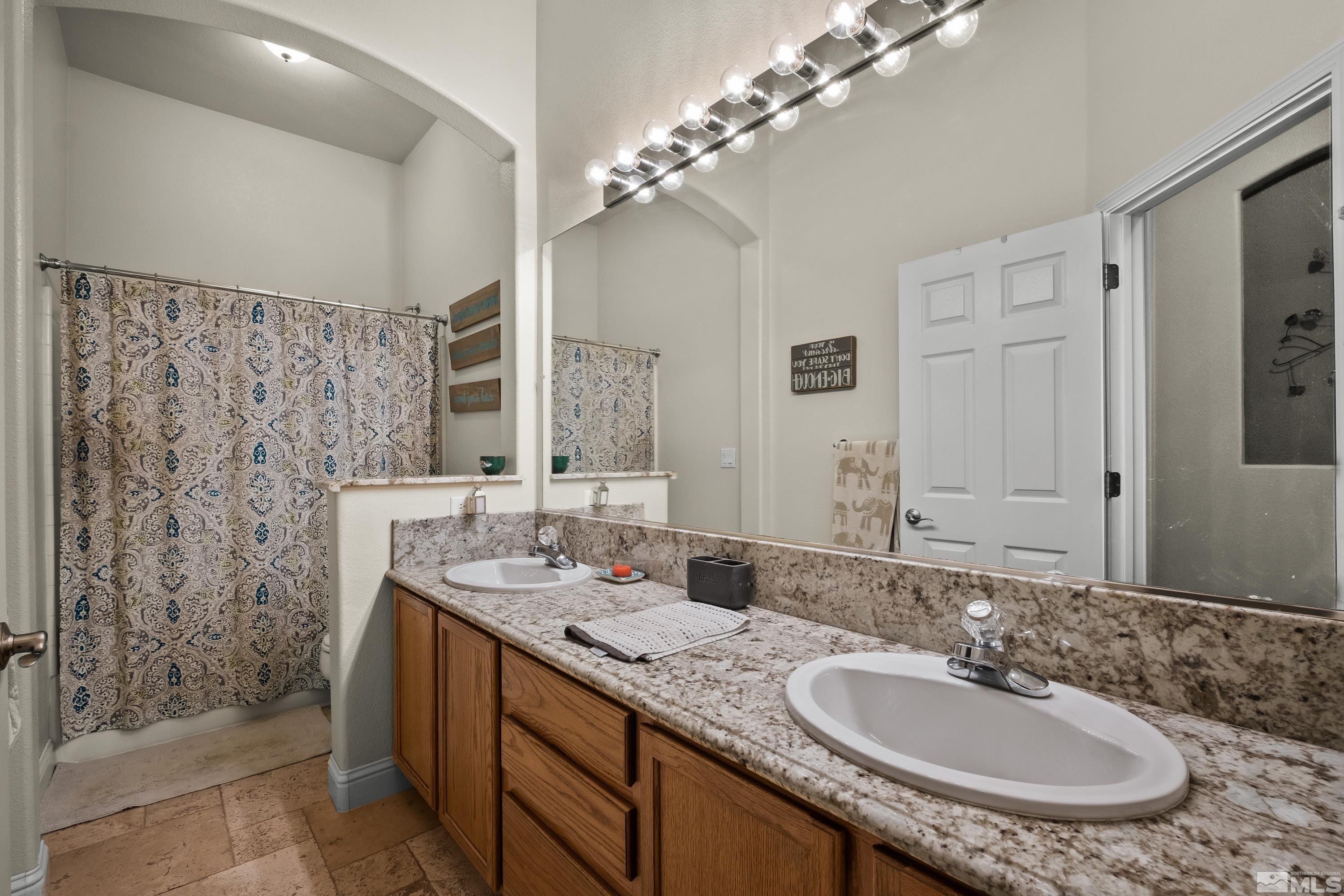 1600 Red Gulch Court Reno, NV 89521 - Photo 20 of 39 a bathroom with a double vanity sink mirror and shower