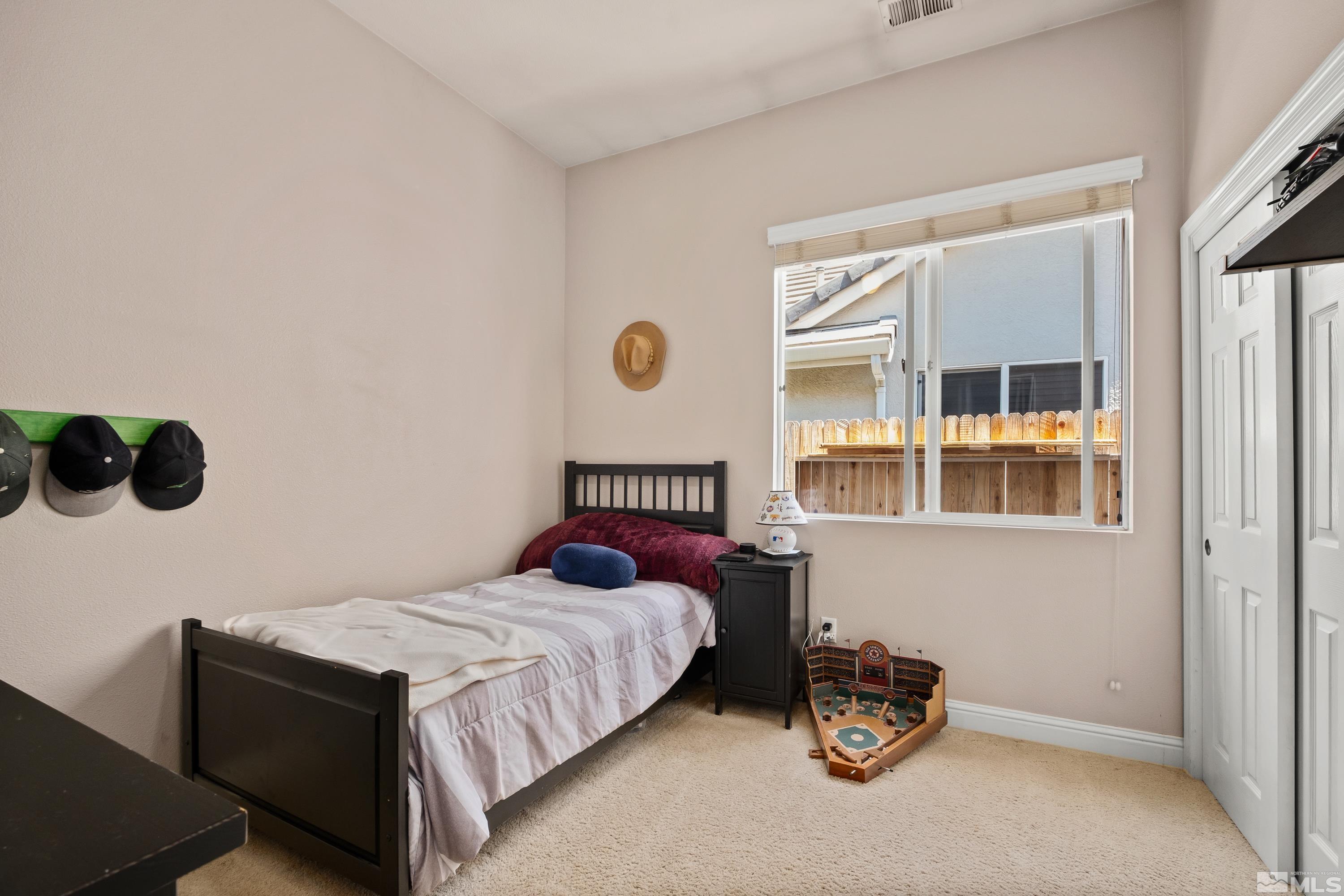 1600 Red Gulch Court Reno, NV 89521 - Photo 21 of 39 a bedroom with a bed and window