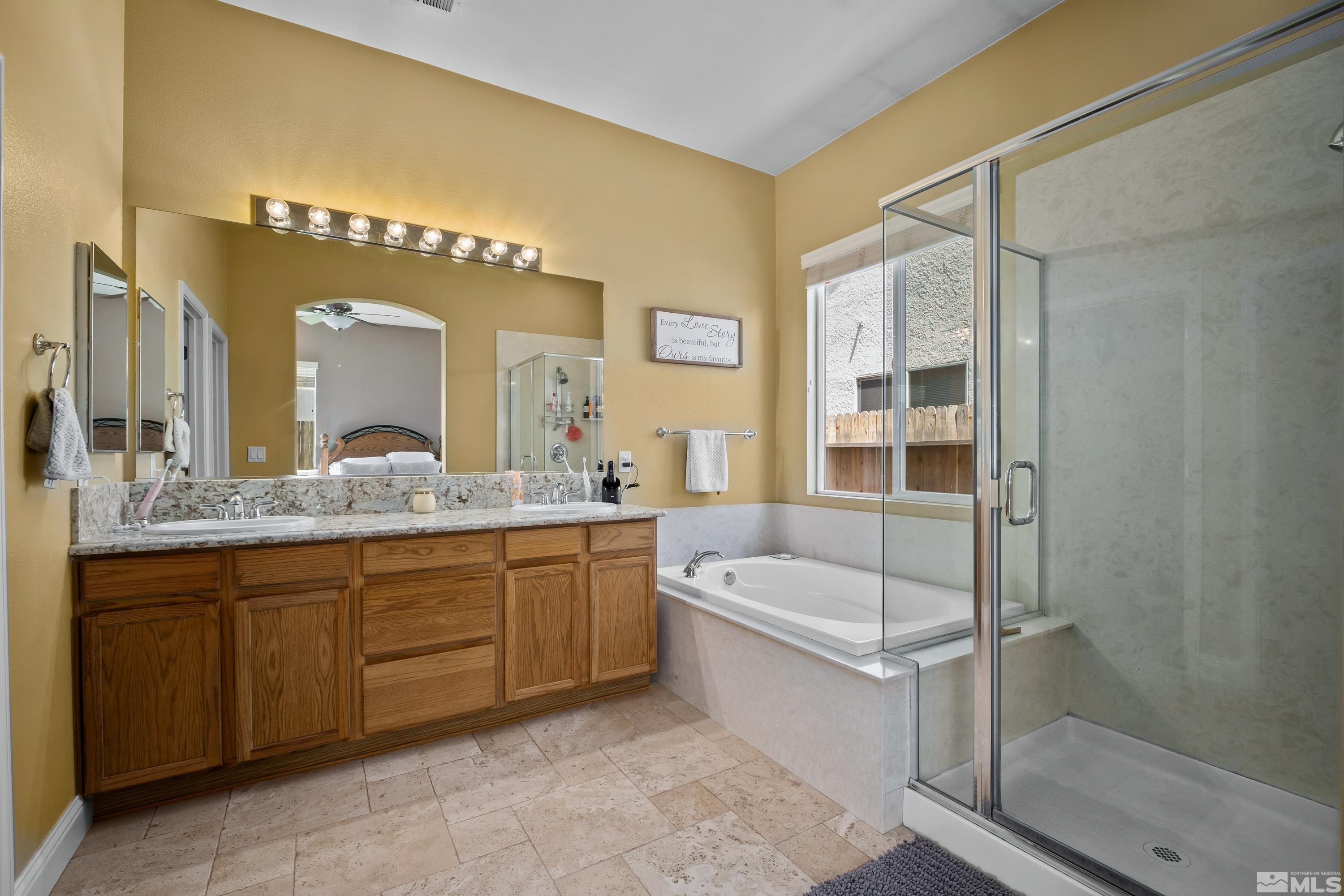 1600 Red Gulch Court Reno, NV 89521 - Photo 27 of 39 a bathroom with a tub a sink and mirror