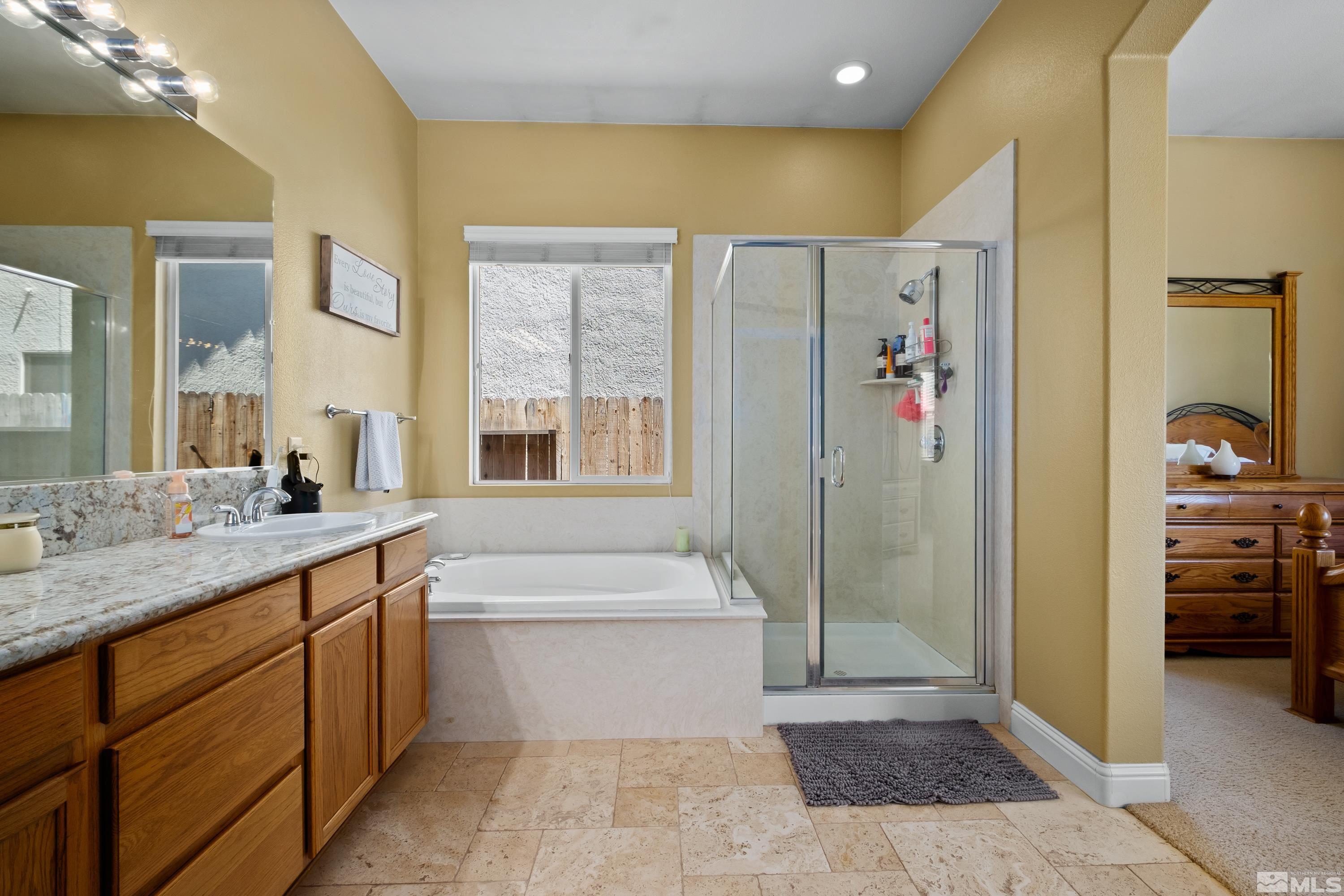 1600 Red Gulch Court Reno, NV 89521 - Photo 28 of 39 a bathroom with a granite countertop sink a mirror and a bathtub