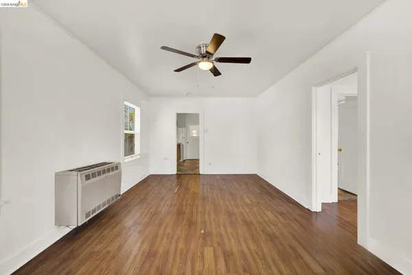 wooden floor in an empty room with a window