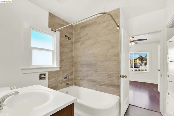 a bathroom with a sink a mirror and a bathtub