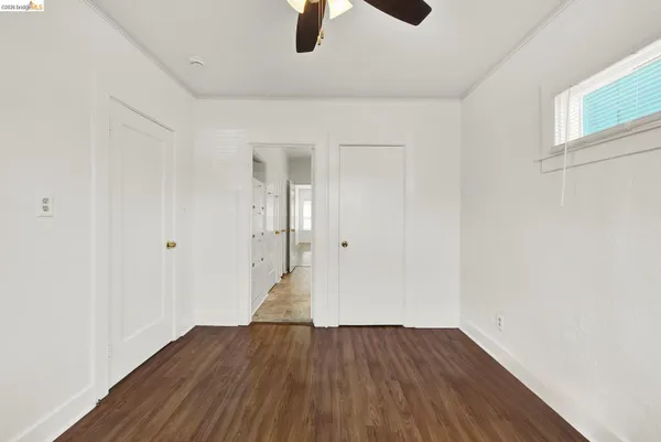 a view of an empty room with wooden floor