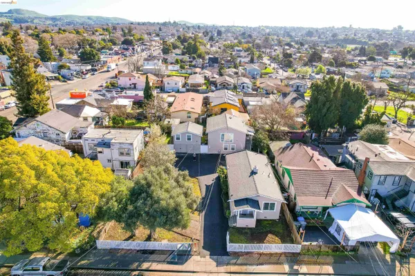 an aerial view of residential houses with outdoor space