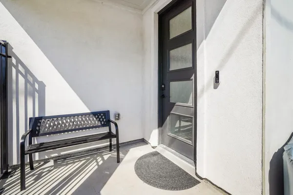 a view of staircase with white walls and a window