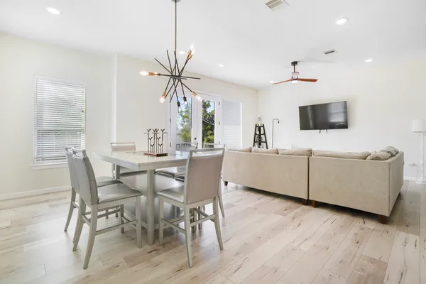 a view of a dining room with furniture and wooden floor